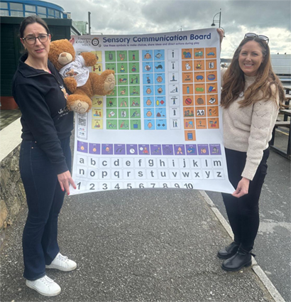 Emer Collects Sensory Communication Board from Lyndsey Walsh of Raising Rareness